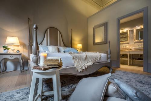 a bedroom with a large bed and a table with candles at Palazzo Ridolfi - Residenza d'Epoca in Florence