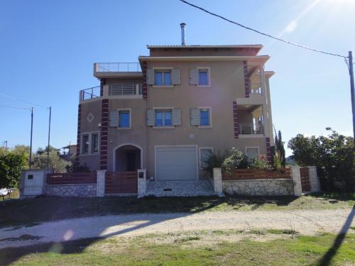 a large house with a garage in front of it at Villa Lydia in Nydri