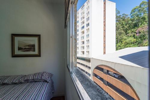 a balcony with a bed and a window at New FLAT 504 in Petrópolis