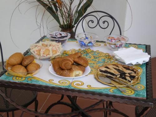 a table with plates of pastries and bread on it at Portico Del Paradiso in Scala
