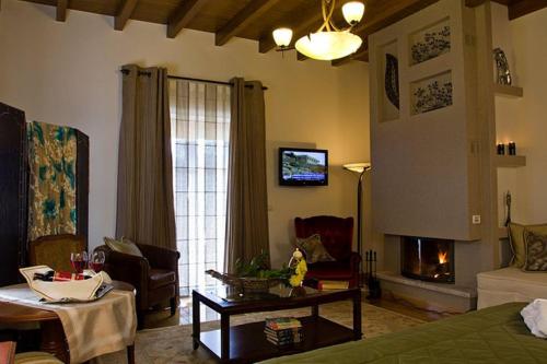 a living room with a couch and a fireplace at Methexis Boutique Hotel in Dhimitsana