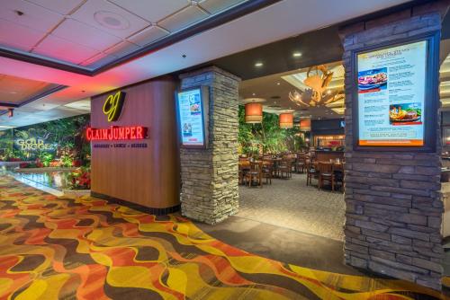a restaurant with a bar with tables and chairs at Golden Nugget Laughlin in Laughlin