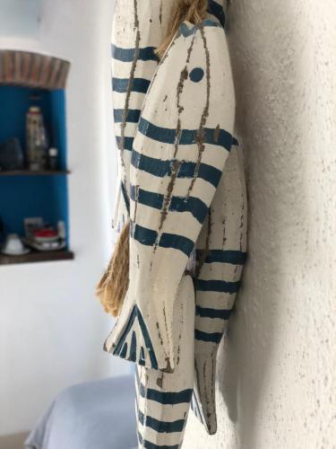 a white and blue towel hanging on a wall at La Polena Camere Vernazza - Visconti Apartment in Vernazza