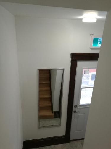 a stairwell in a room with a mirror at Ambassador's Inn Next Door in Stratford