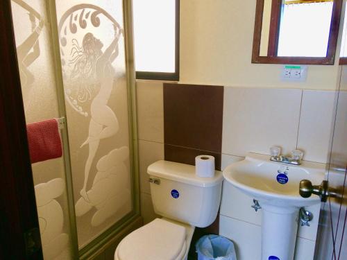 a bathroom with a toilet and a sink at Dos Hemisferios in Quito