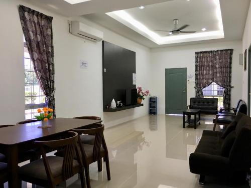 a living room with a table and chairs at MyHome Ganggarak in Labuan