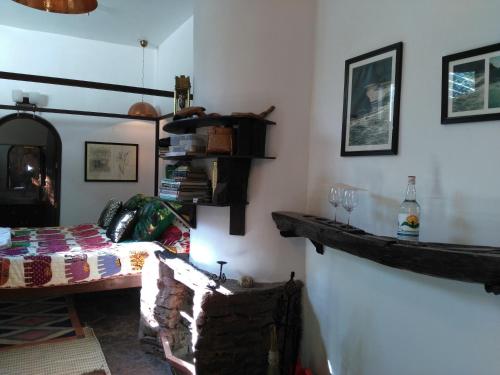a room with a bed and a table in it at Samira's Birds & Butterflies Park-Spashram Ganga Beach Retreat in Rishīkesh