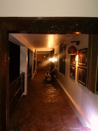 a long hallway with benches in a building at Samira's Birds & Butterflies Park-Spashram Ganga Beach Retreat in Rishīkesh