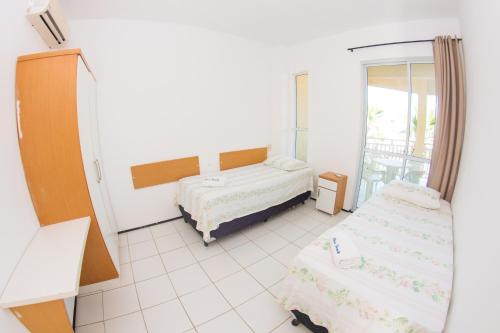 a room with two beds and a mirror at Blue Beach Temporada in Aquiraz