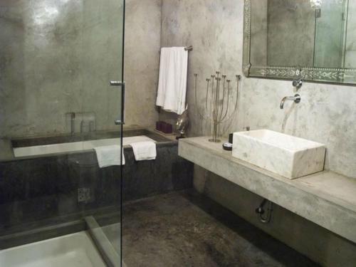 a bathroom with a sink and a glass shower at Pocinhobay in Madalena