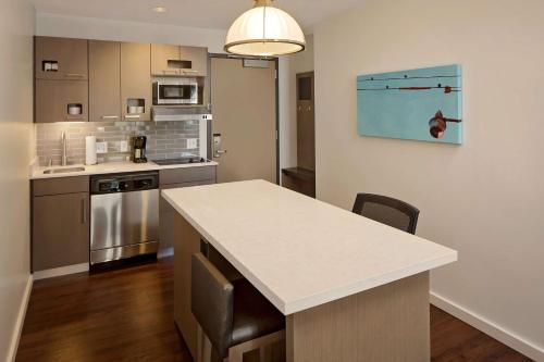 a kitchen with a white counter top in a room at Hyatt House Irvine/John Wayne Airport in Irvine