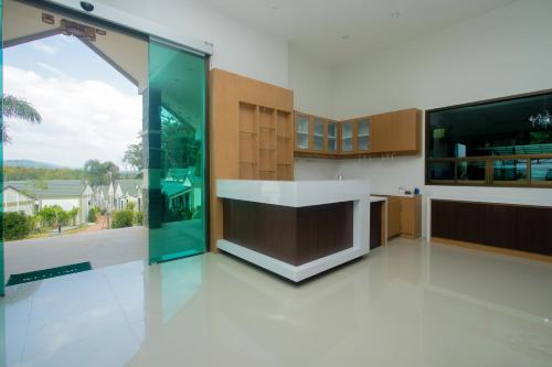 a large kitchen with a large window and a counter at Saichon Grand View in Ban Lam Rua Taek