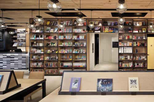 a book store with shelves of books at LAMP LIGHT BOOKS HOTEL nagoya in Nagoya