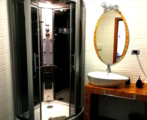 a bathroom with a sink and a mirror at B&B Black&White and apartments in Cantù