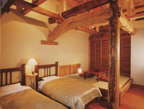 A bed or beds in a room at Hotel Yunojin