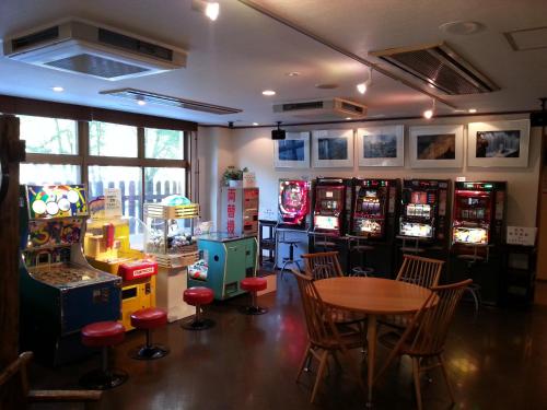 a room with a table and several slot machines at Hotel Yunojin in Minakami