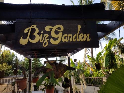a sign for a big garden with potted plants at Big Garden Homestay in Pantai Remis