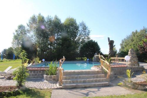 a swimming pool in a yard with stairs next to it at Hotel "Untere Mühle" in Schwabmühlhausen