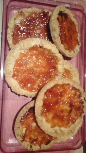 a pink tray with four pies with jam on them at Roma Gianicolense in Rome