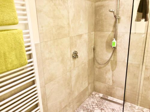 a bathroom with a shower with a glass door at Landhotel Witte-König in Garrel