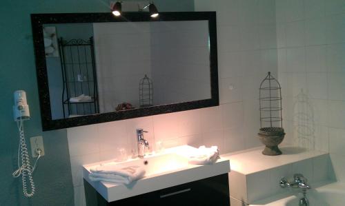 a bathroom with a sink and a mirror at L' Oustaloun in Maussane-les-Alpilles