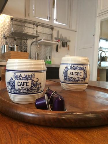 three blue and white bowls on a wooden table at Appartamento Louer 2 in Parma