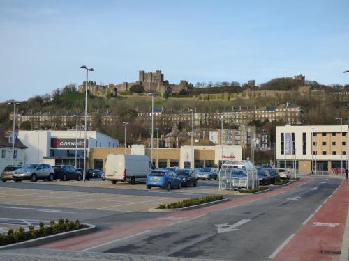 a parking lot with a castle on top of a hill at Maison Dieu Guest House in Dover