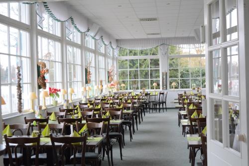 a dining room with tables and chairs and windows at Neu-Helgoland in Berlin