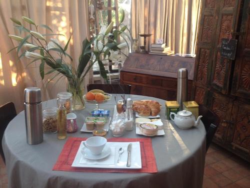 a table with a table cloth with food on it at LE 17 in Courthézon