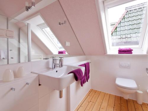 a bathroom with a sink and a toilet at Hotel Villa Caldera in Cuxhaven