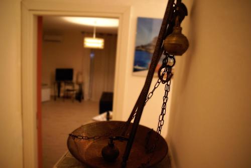 a metal bowl hanging on a wall with a chain at La Porta dell'Alcantara in Gaggi