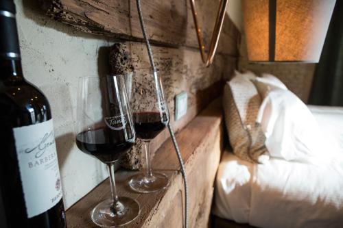 two glasses of red wine sitting on a shelf at La Canonica - charming self-catering apartments in Nizza Monferrato in Nizza Monferrato