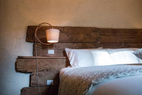 a bedroom with a bed with a lamp next to it at La Canonica - charming self-catering apartments in Nizza Monferrato in Nizza Monferrato