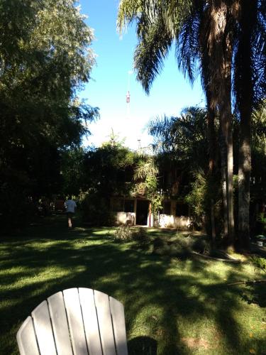 a white chair sitting in the middle of a yard at Cabañas ICh in Tigre