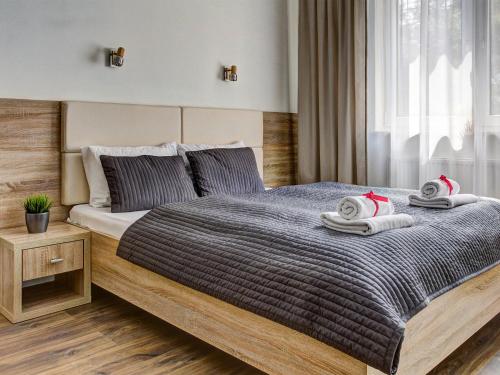 a bedroom with a large bed with towels on it at Apartamenty w Marina Jastrzębia Góra in Jastrzębia Góra