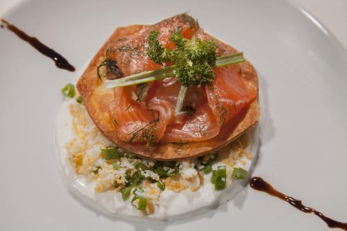 a glass container with a tomato on top of rice at Solun's Riverside Rooms in Skopje