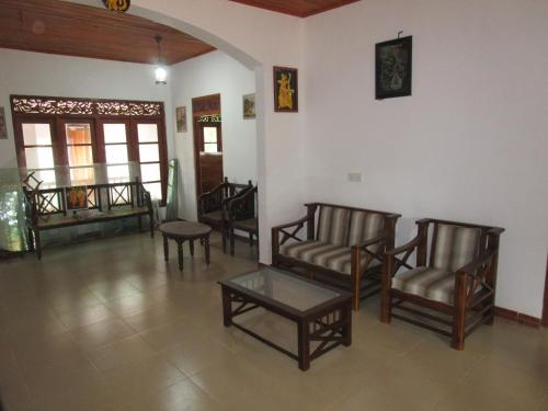 a living room with chairs and a coffee table at Green Herbal Ayurvedic Eco-Lodge in Galle