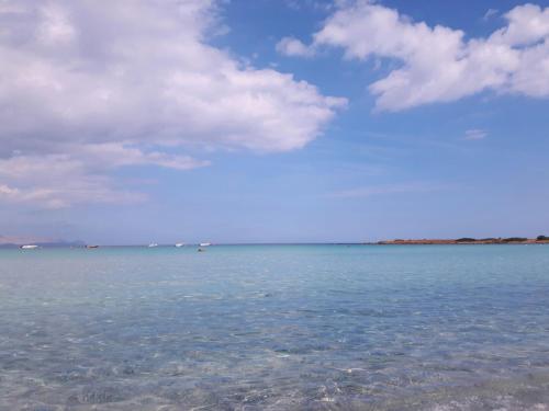 a large body of water with a blue sky and clouds at Casa Carla in Budoni
