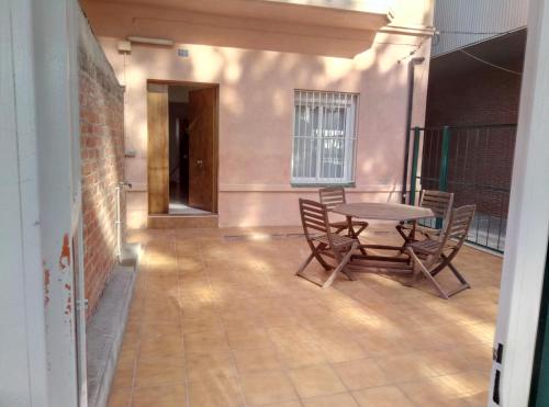 a patio with a table and chairs in a room at Casa Carmen Barcelona in El Prat de Llobregat