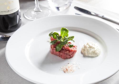 a white plate with a piece of food on a table at Castello di Gabiano in Gabiano