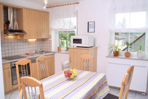 a kitchen with a table with a bowl of fruit on it at Weingut Sauer-Kettermann in Enkirch