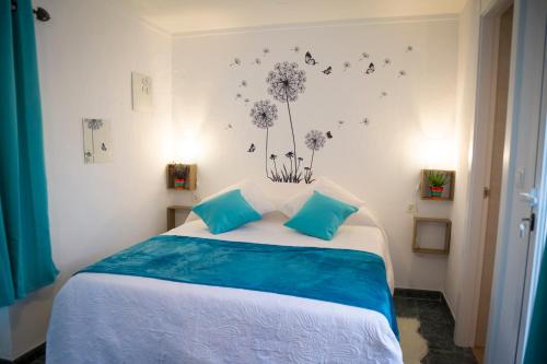 a bedroom with a bed with dandelions on the wall at La Casa Del Recreo in Cómpeta