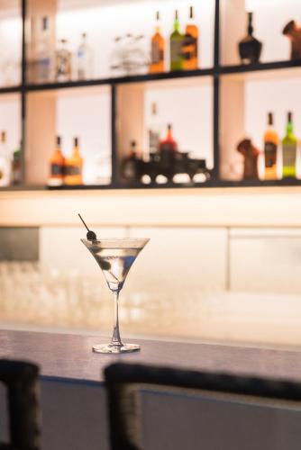 a martini glass sitting on a counter in a bar at Hyatt Regency Lucknow Gomti Nagar in Lucknow