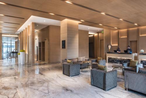 a lobby with couches and chairs in a building at Hyatt Regency Lucknow Gomti Nagar in Lucknow