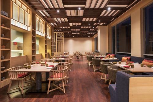 a dining room filled with tables and chairs at Hyatt Regency Lucknow Gomti Nagar in Lucknow