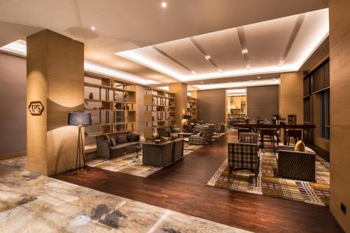 a lobby with couches and chairs and a table at Hyatt Regency Lucknow Gomti Nagar in Lucknow