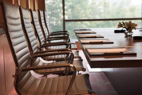 a row of chairs at a table in a room at Hyatt Regency Lucknow Gomti Nagar in Lucknow