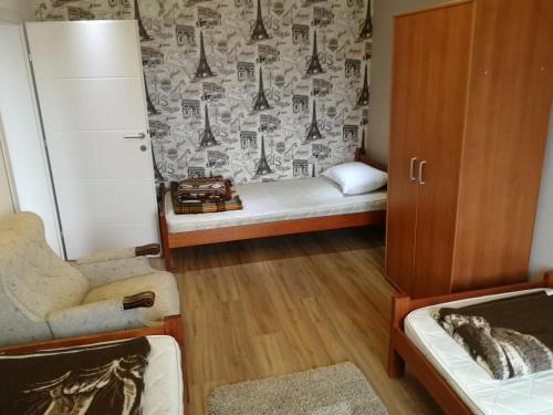 a small room with a bed and a chair at Apartments "Predah kod Baraća" in Niš