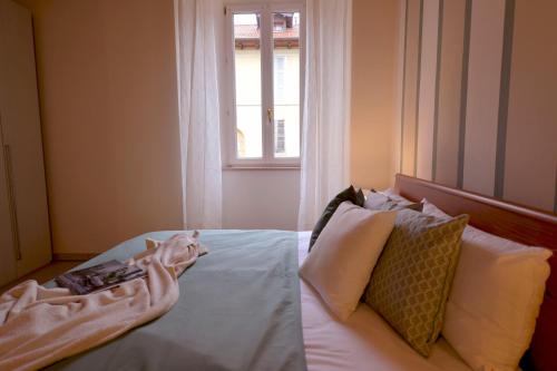 a bedroom with a bed and a window at Casa Josa - WelcHome in Cannobio