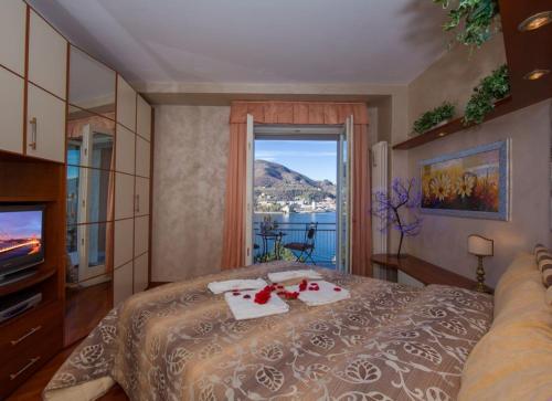 a bedroom with a bed with a view of the water at Lo Specchio Sul Lago - The House Of Travelers in Como